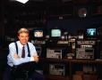 Photograph: [Photograph of Scott Murray in a room with monitors]