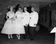 Photograph: [Bride and groom with two individuals]