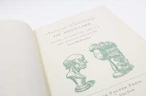 Closeup of a green illustration on the title page, the one on the left is of a mans head, and the one on the right in the shape of a hand.