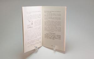 An open white booklet with black text.