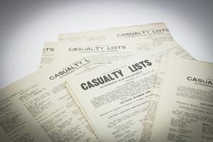 Detail of a stack of news pages, all titled Casualty Lists with text under it.