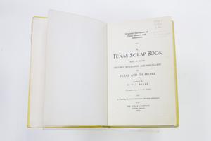 An open book with the page on the left being blank and the page on the right containing the title page.