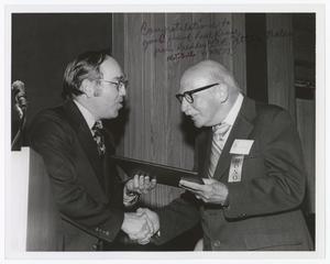 Primary view of object titled '[Paul Kruse accepting a certificate from University President C.C. "Jitter" Nolen]'.