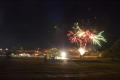 Photograph: [Green, red, and white bursts of fireworks]