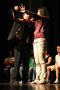 Photograph: [Hypnotist and participant on stage]