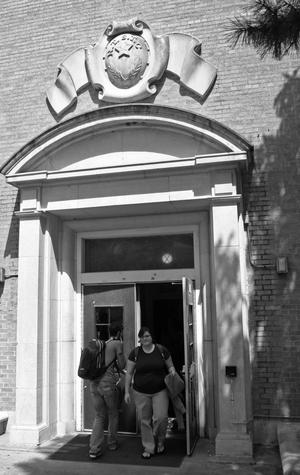 Primary view of object titled '[Students passing through Bruce Hall entrance]'.