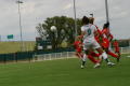 Photograph: [Players watching soccer ball in air]