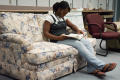 Photograph: [Kayla Smith reading on couch]
