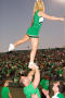 Photograph: [Cheer team and alumni performing at Homecoming game, 2007]