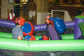 Photograph: [Students fighting in inflatable boxing ring]
