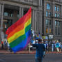 Photograph: [Protester holding flag at Fort Worth Courthouse]