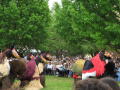 Photograph: [People in horse costumes and crowd watching]