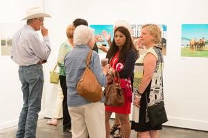 Primary view of object titled '[Small crowd at exhibit reception]'.