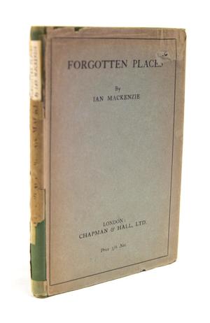 An old book cover, the spine of it torn off and showing green. The title of the book is at the top of the cover.