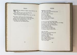 A book open, the page on the left containing text titled Peace. The page on the right containing a poem of three stanzas, titled Desire.