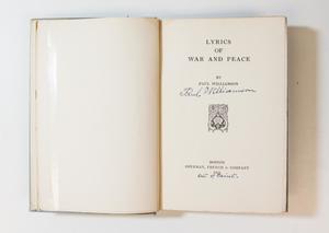 A book open, the page on the left blank, the page on the right containing the title page.