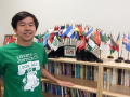 Photograph: [Student in front of flag display in MC offices]