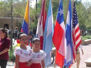 Primary view of object titled '[Two girls beside flags at 2008 Carnaval]'.