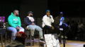 Primary view of [Men speaking on the stage in the Syndicate]