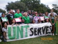Photograph: [Gilda Garcia and students holding UNT SERVES banner 1]