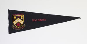 A black flag, with the words New Zealand on it in red. To the left of it a golden shield symbol, with the Word Canerbury above it in red.
