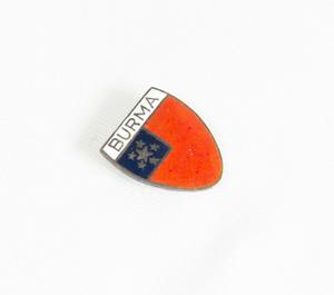 A pin with word Burma at the top of it in a white line. Under that, it is orange with a box of blue with stars on the left side of it.