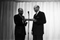 Primary view of [Stanley Marcus presenting a certificate]