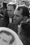 Photograph: [Richard Nixon standing among a crowd]