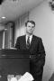 Photograph: [Robert F. Kennedy leaning against a podium]