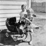 Photograph: [Photograph of Carol and Tim standing next to a stroller]