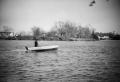 Photograph: [Photograph of a man in a boat on a lake]