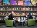 Photograph: [Two men in Multicultural Center library]