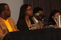 Photograph: [Young woman speaking on panel during 2012 TABPHE conference]