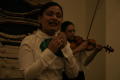 Photograph: [Mariachi singer and violinist at 2004 La Raza graduation]