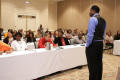Photograph: [Man speaking to table groups at 2012 TABPHE workshop 2]