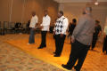 Photograph: [Men lined up to dance at 2012 TABPHE conference 1]