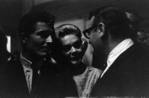 Primary view of object titled '[Actress and singer Alice Faye speaking with a gentleman]'.