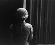 Photograph: [Alice Faye standing backstage by the curtain, 2]