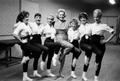 Photograph: [Alice Faye posing with dancers for portrait]