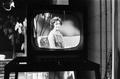 Photograph: [A woman on a television screen]
