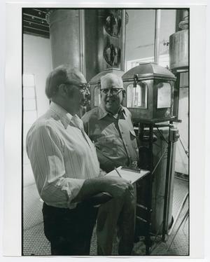 Primary view of object titled '[Two men taking readings from the distillery]'.