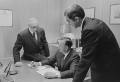 Photograph: [John DeLorean, Ed Cole and another man in an office, 3]
