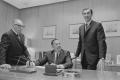 Photograph: [John DeLorean, Ed Cole and another man in an office, 8]