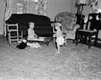 Photograph: [Byrd and Pam playing in a living room]