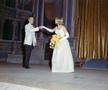 Photograph: [Man and woman dancing on a stage, dressed in formal attire, woman ho…