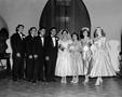 Photograph: [Bride and groom with their wedding party]