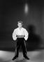 Photograph: [Boy in wide pants and a collared shirt, standing]