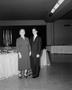 Photograph: [An older woman and young man standing in formal attire]