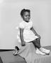 Photograph: [Little girl in a dress, sitting]