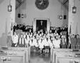 Photograph: [Group of children and adults in a church]